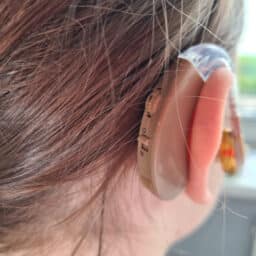 Close up of a hearing aid on a young girl