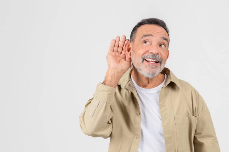 Man on white background holding his hand to his ear