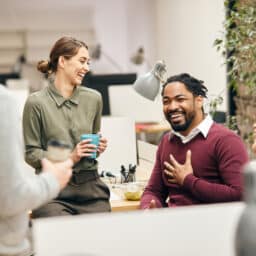 Happy business team having fun while talking on their coffee break in the office